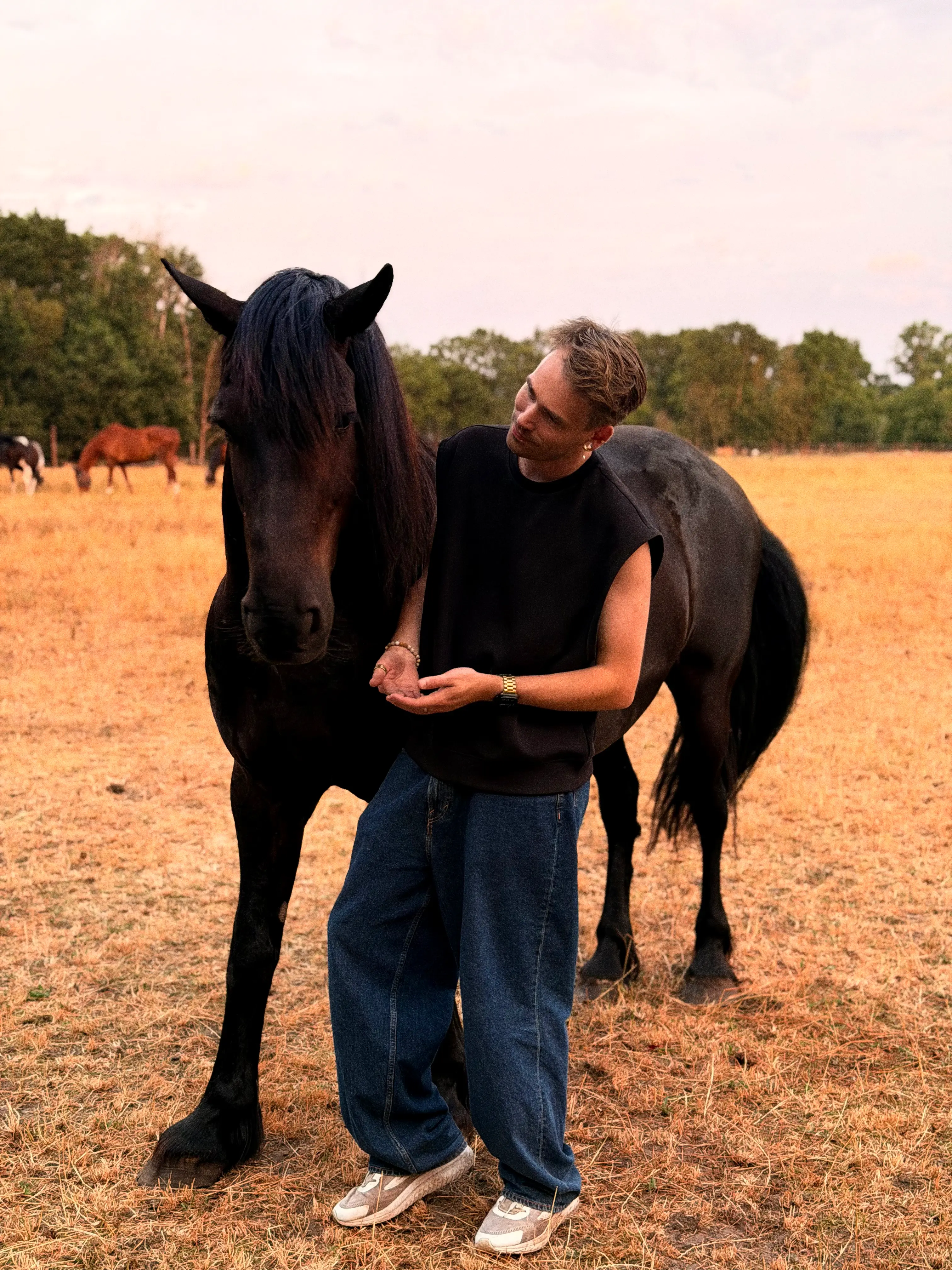 Jeffrey Lanters with a horse in a field